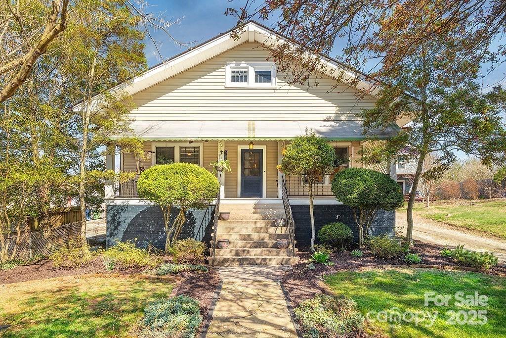 127 Pennsylvania Avenue Asheville, NC 28806 - Photo 1 of 48 a front view of house with a garden and patio