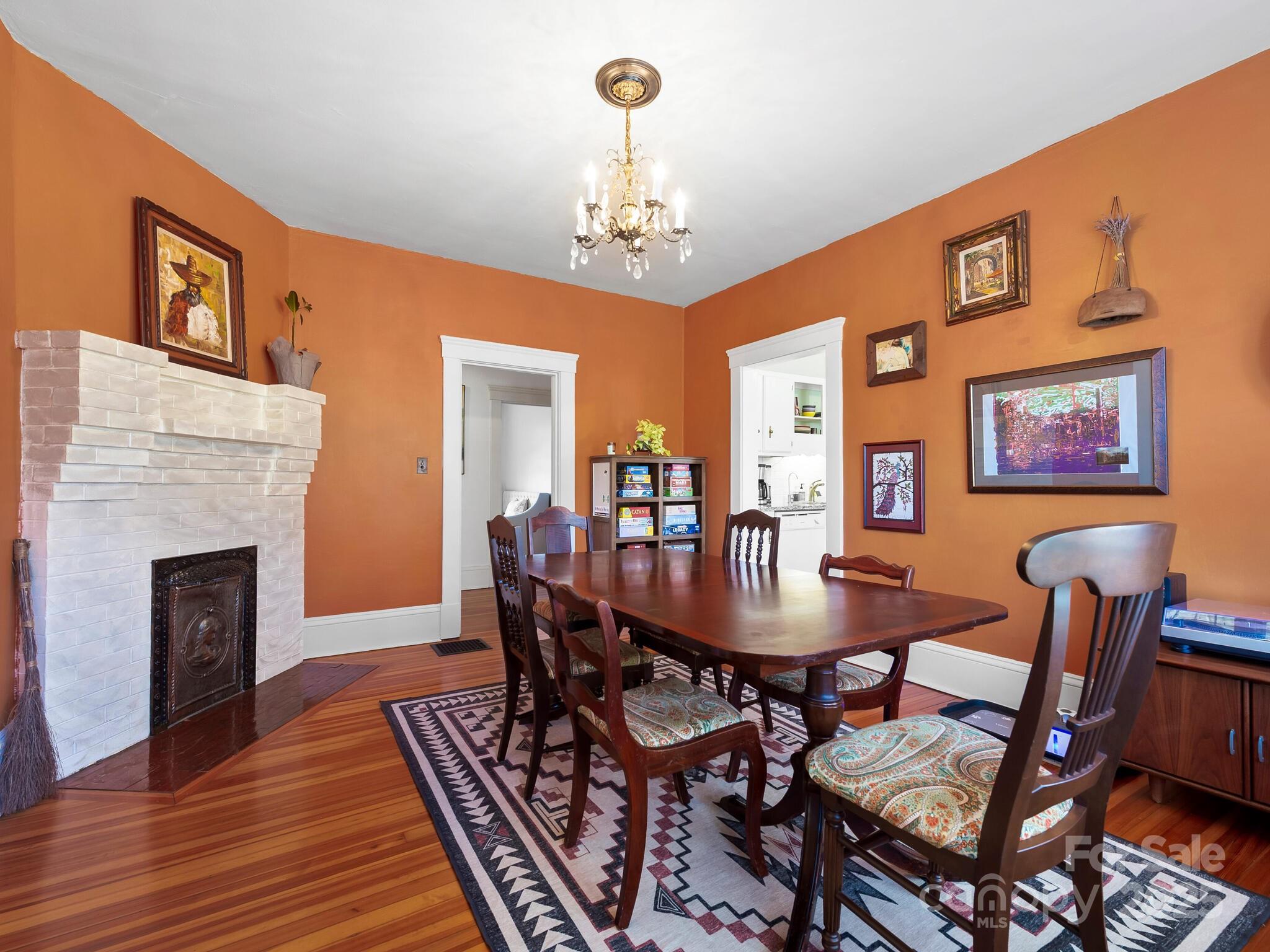 127 Pennsylvania Avenue Asheville, NC 28806 - Photo 14 of 48 a view of a dining room with furniture wooden floor and chandelier