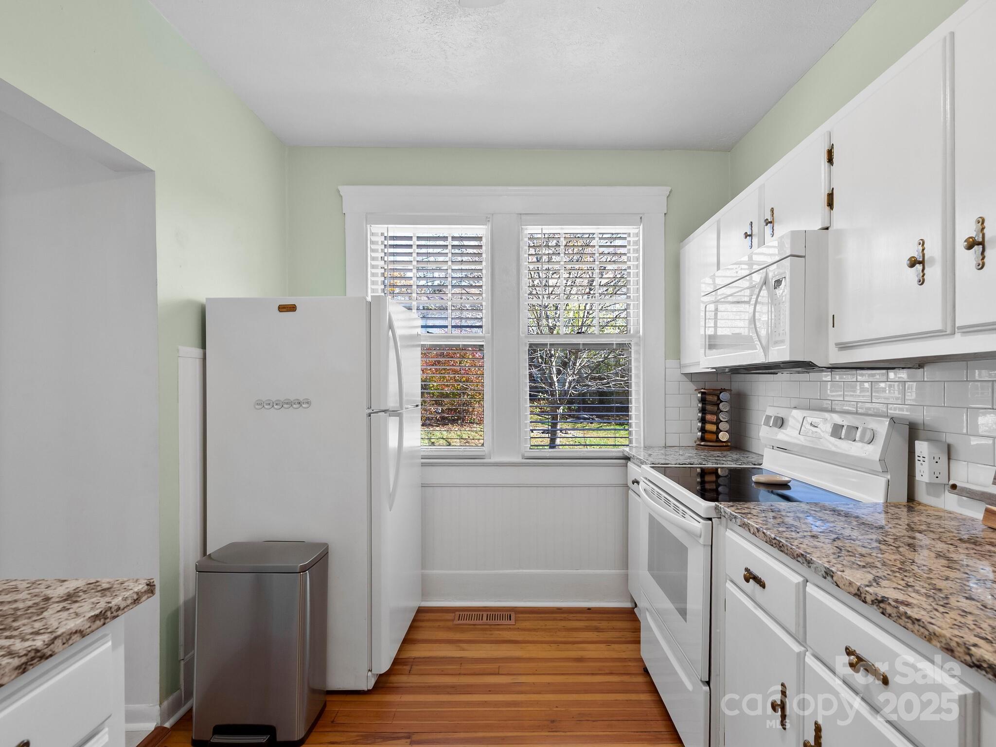127 Pennsylvania Avenue Asheville, NC 28806 - Photo 19 of 48 a kitchen with stainless steel appliances granite countertop a stove a sink and a refrigerator
