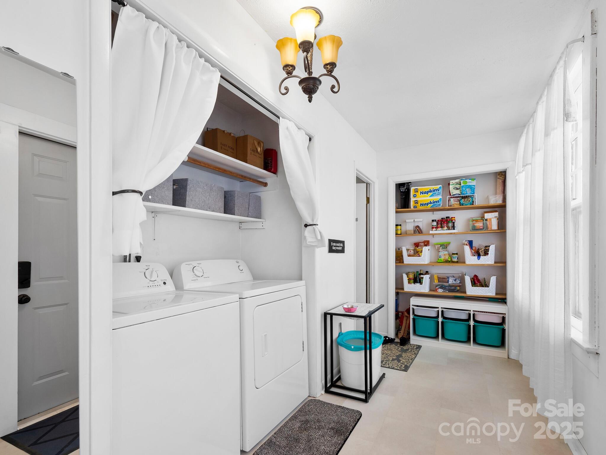 127 Pennsylvania Avenue Asheville, NC 28806 - Photo 21 of 48 a bedroom with a bed and a chandelier