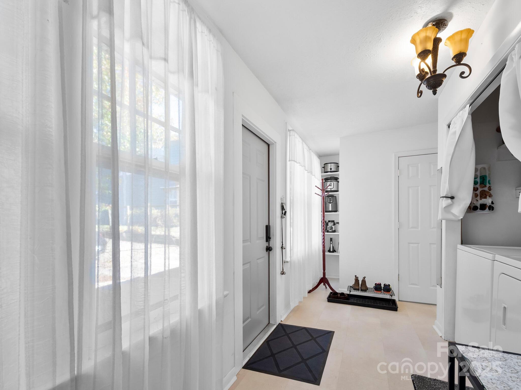 127 Pennsylvania Avenue Asheville, NC 28806 - Photo 22 of 48 a room with a bed and a chandelier