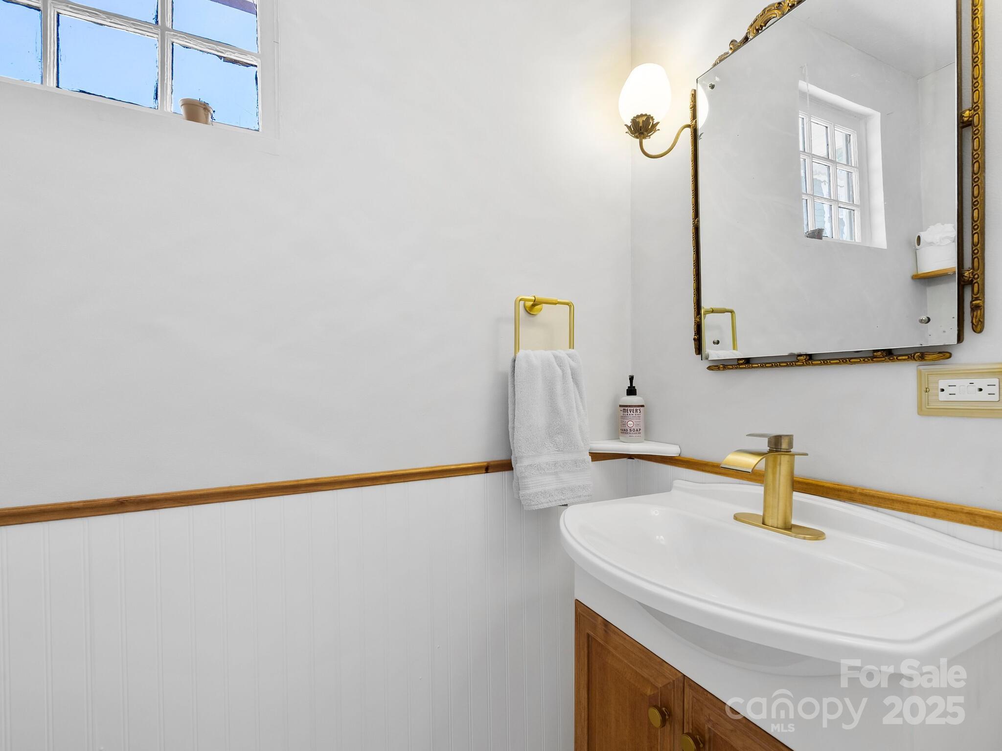 127 Pennsylvania Avenue Asheville, NC 28806 - Photo 23 of 48 a bathroom with a sink and a mirror