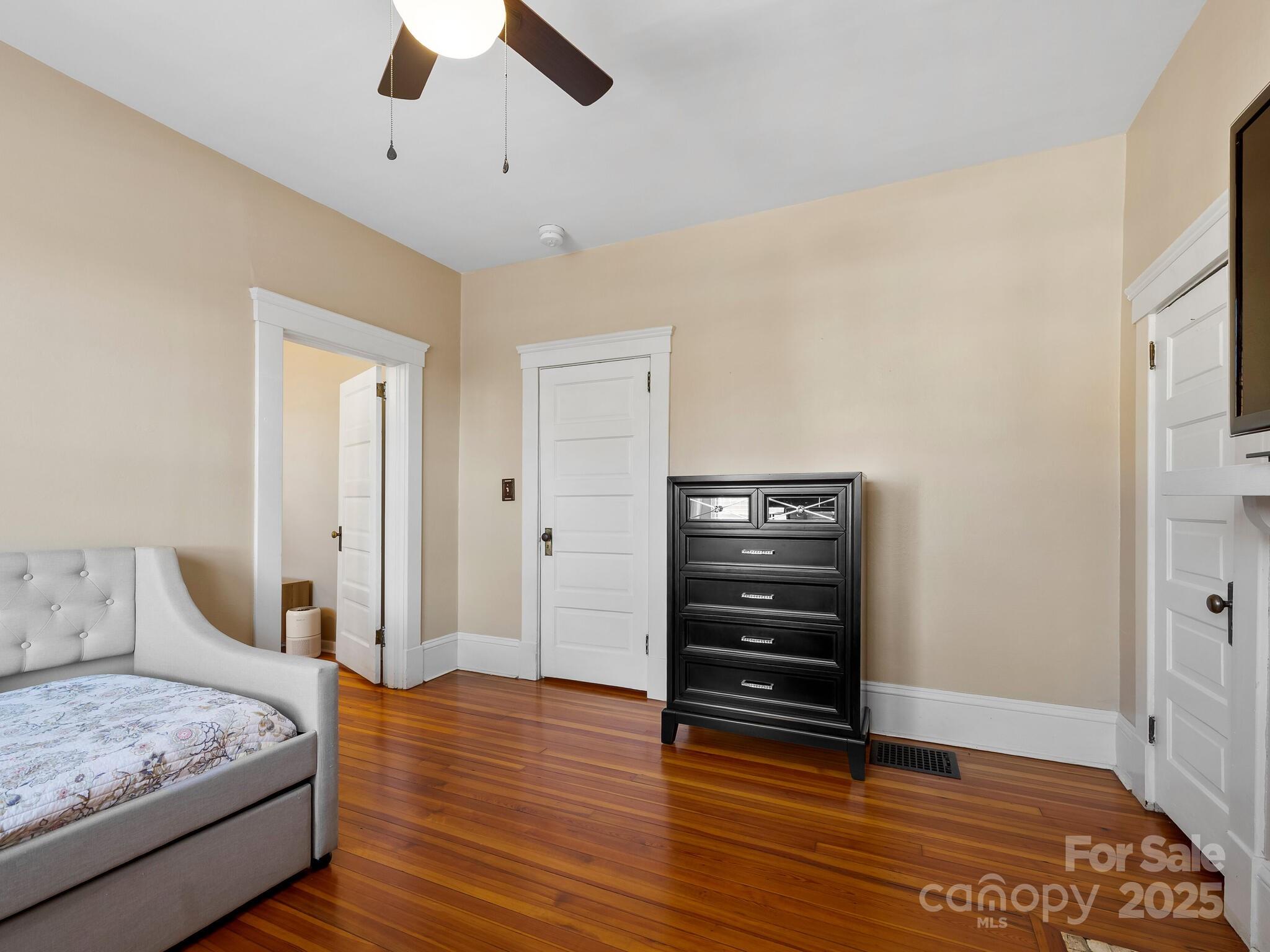127 Pennsylvania Avenue Asheville, NC 28806 - Photo 31 of 48 a bedroom with a bed and wooden floor