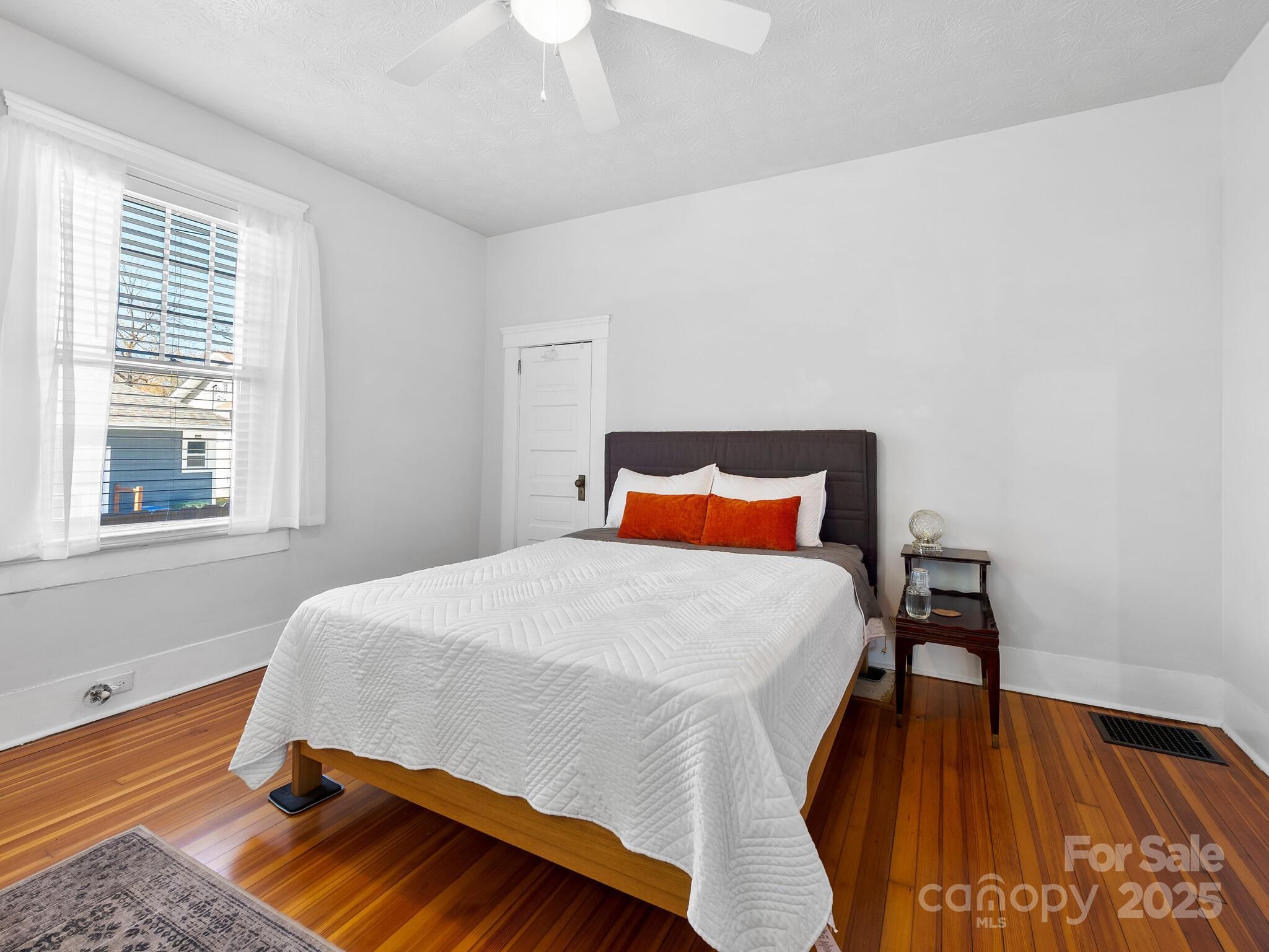 127 Pennsylvania Avenue Asheville, NC 28806 - Photo 34 of 48 a bed sitting in a bedroom next to a window