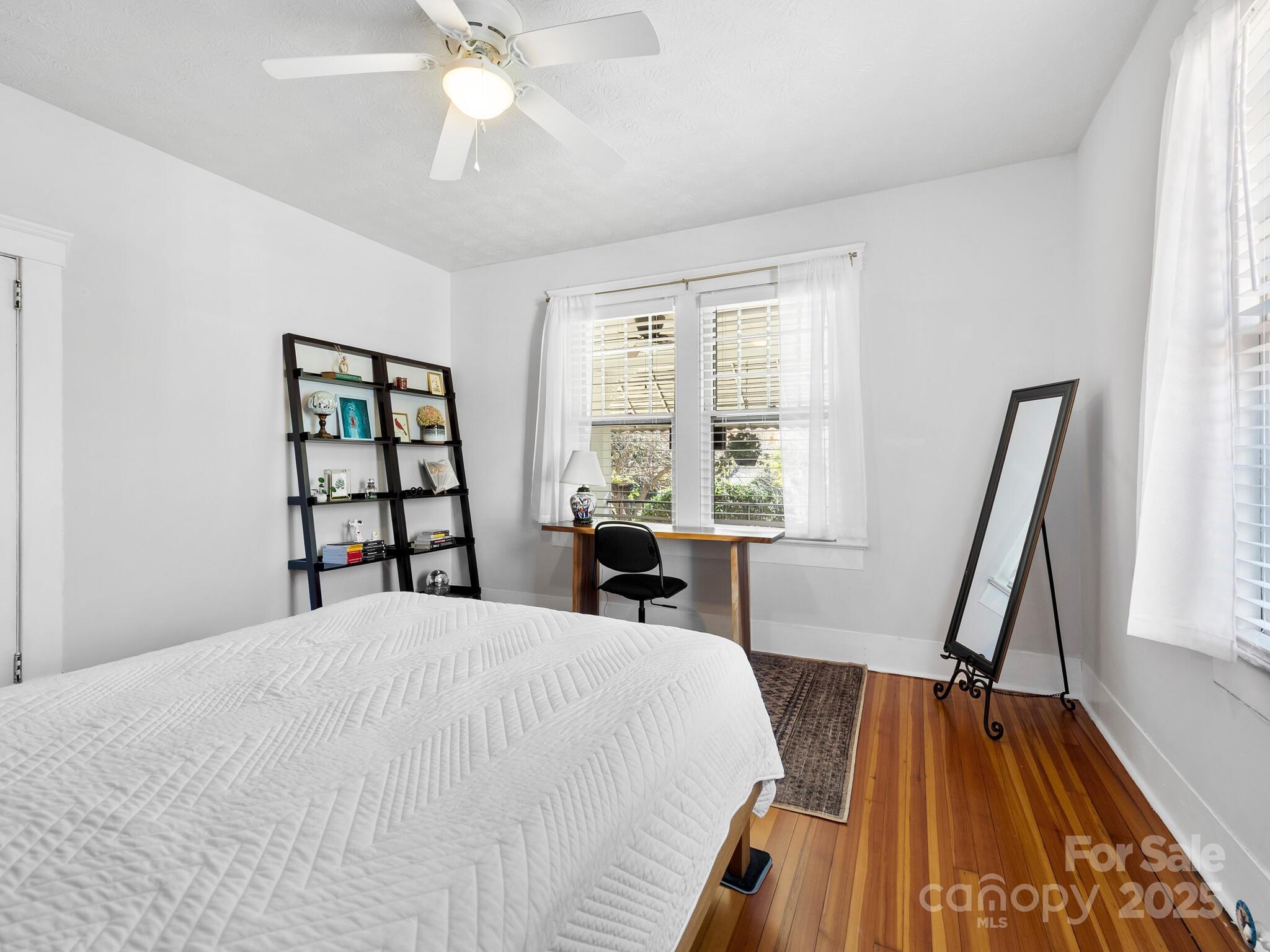 127 Pennsylvania Avenue Asheville, NC 28806 - Photo 35 of 48 a bedroom with a bed and a table