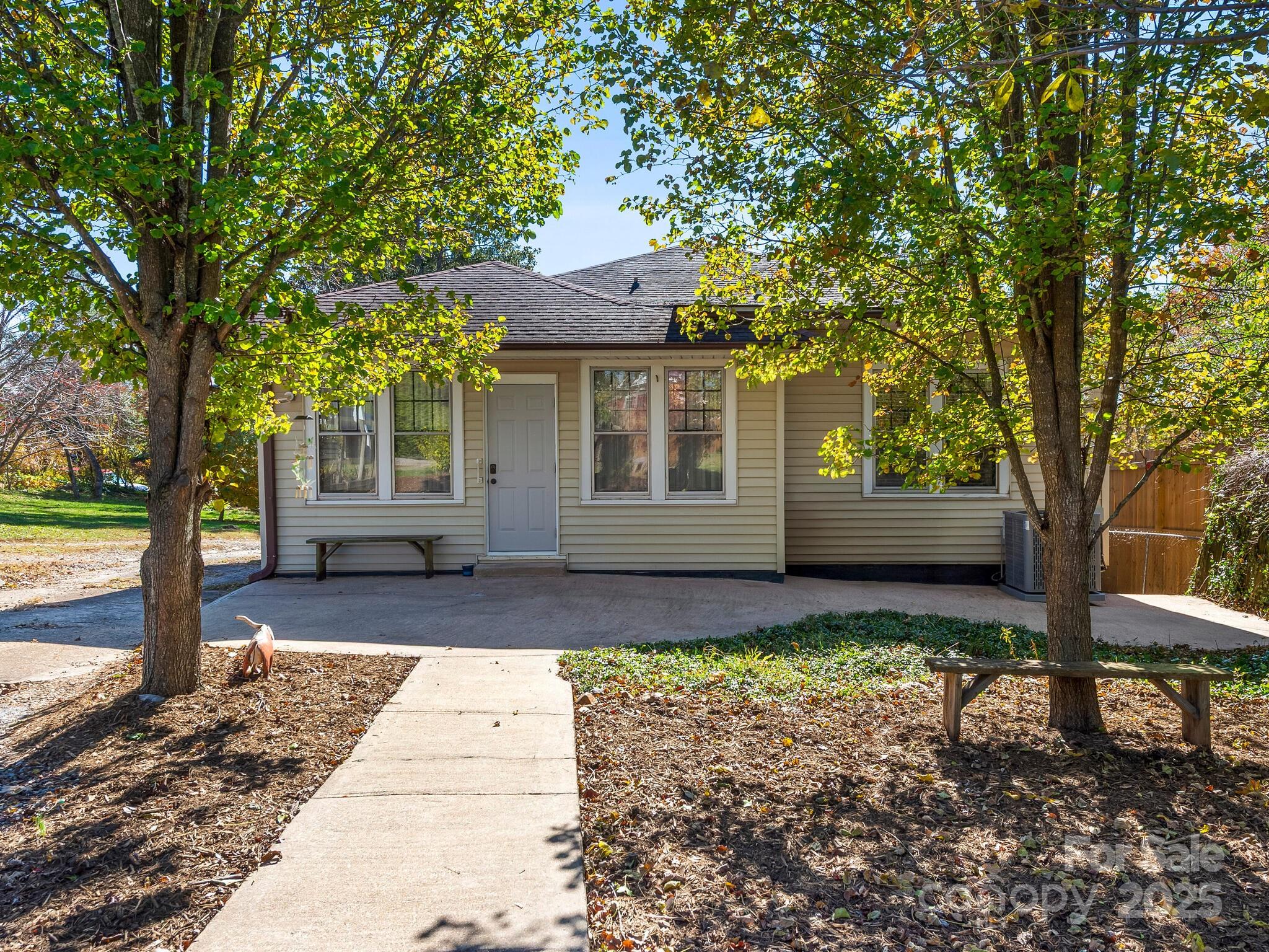 127 Pennsylvania Avenue Asheville, NC 28806 - Photo 43 of 48 a front view of a house with a garden and trees