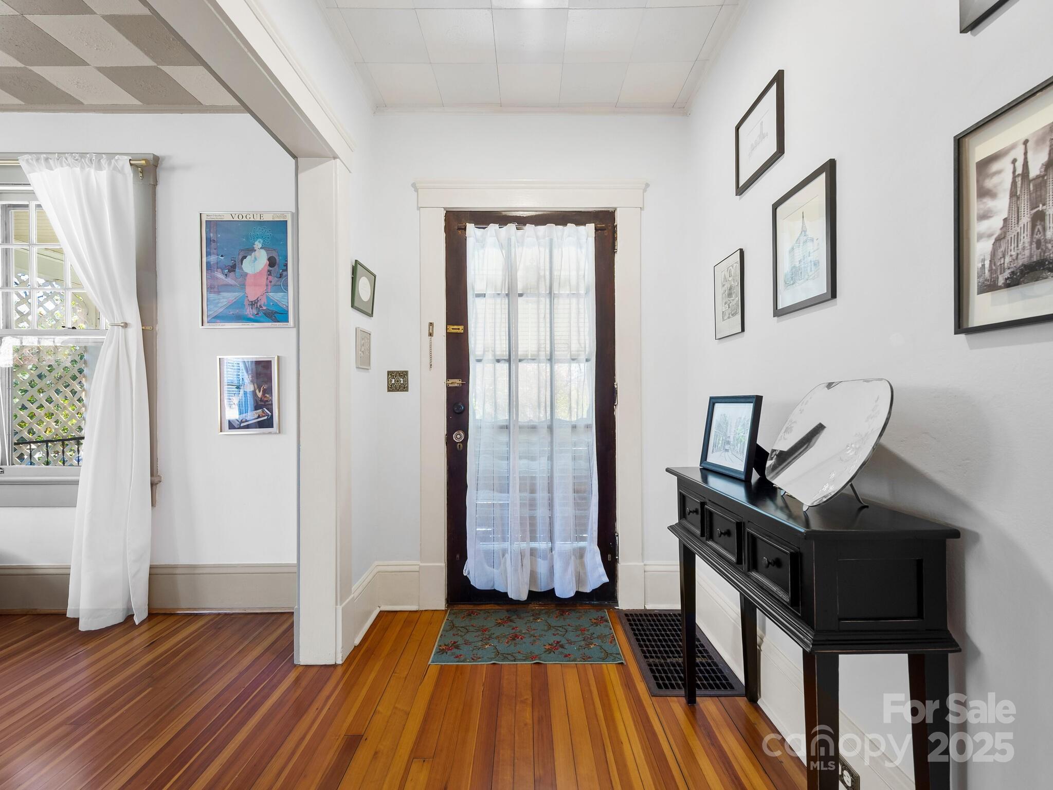 127 Pennsylvania Avenue Asheville, NC 28806 - Photo 5 of 48 a view of a hallway with wooden floor and staircase