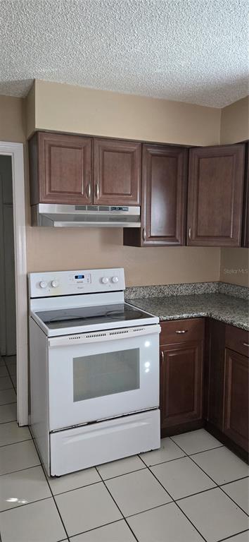 2530 Georgia Avenue, Unit B Sanford, FL 32773 - Photo 2 of 48 a stove top oven sitting inside of a kitchen with granite countertop cabinets