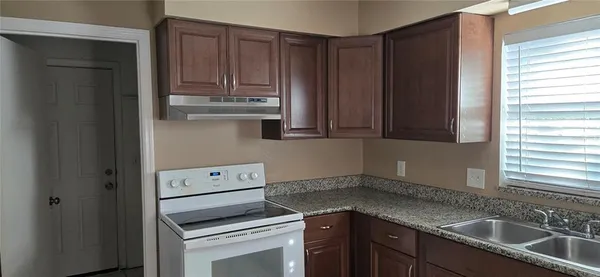 a kitchen with a sink cabinets and window