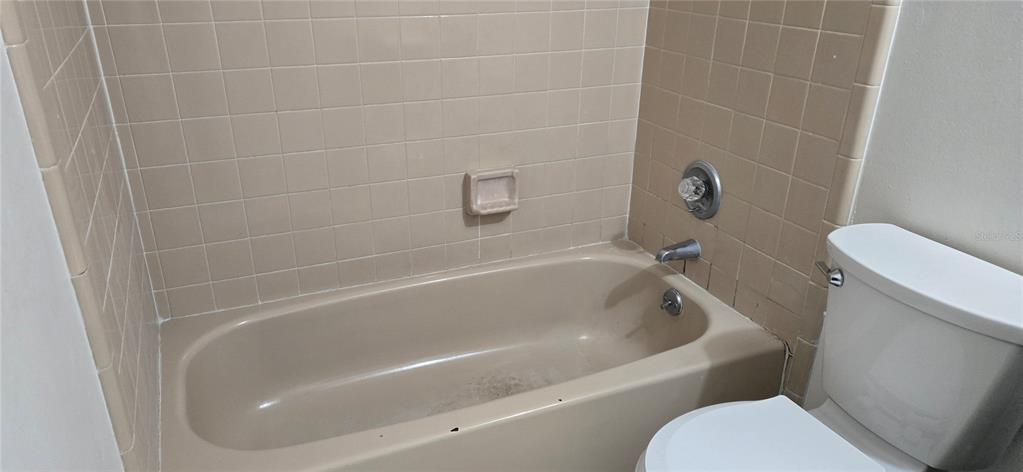2530 Georgia Avenue, Unit B Sanford, FL 32773 - Photo 31 of 48 a white bath tub sitting next to a toilet