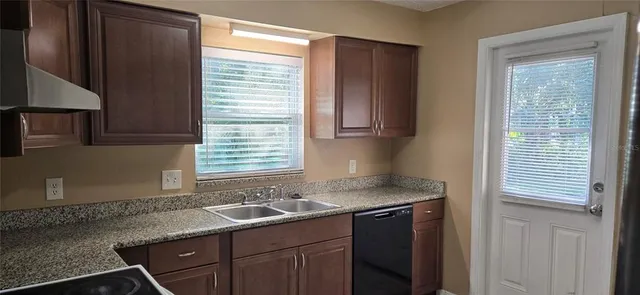 a kitchen with a refrigerator and cabinets