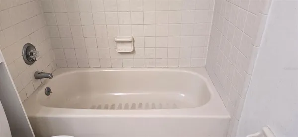 a view of bathroom with shower and cabinets
