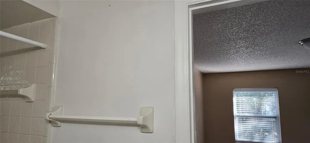 a room with a washing machine and cabinets