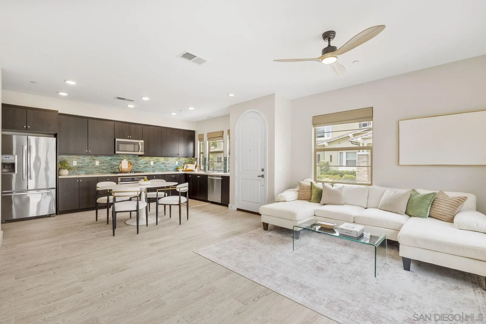 a living room with furniture and kitchen view