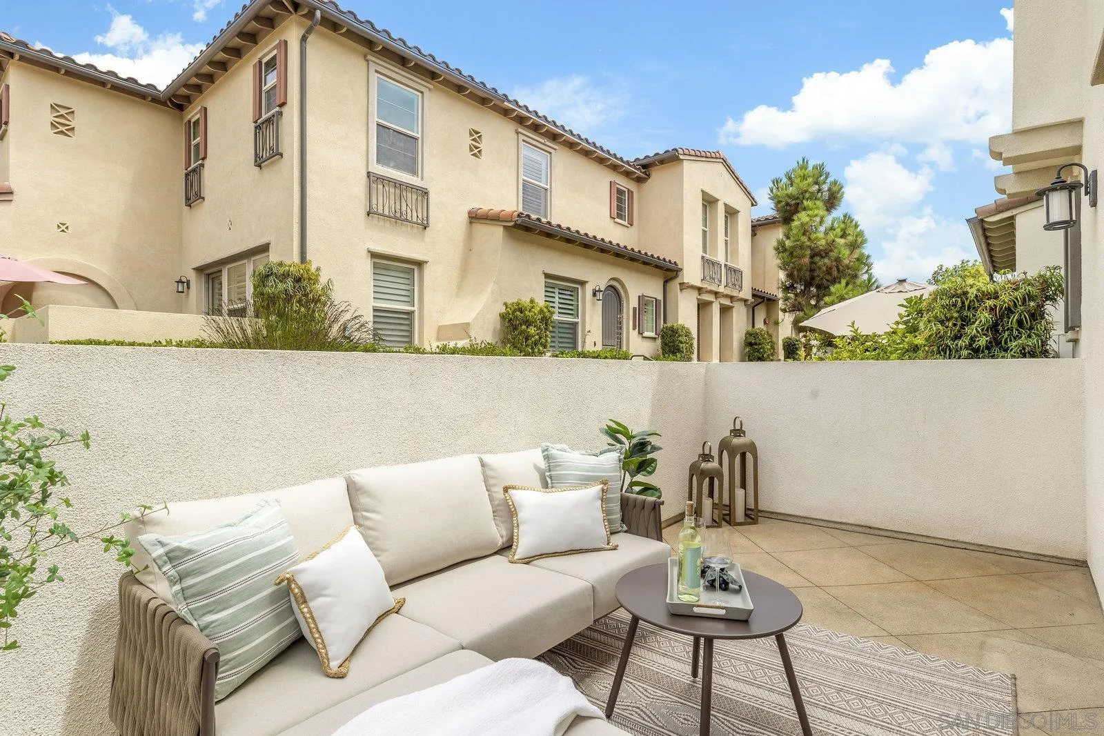 1676 Shorebreak Way Encinitas, CA 92024 - Photo 21 of 61 a view of a patio with couches and a potted plant on a table