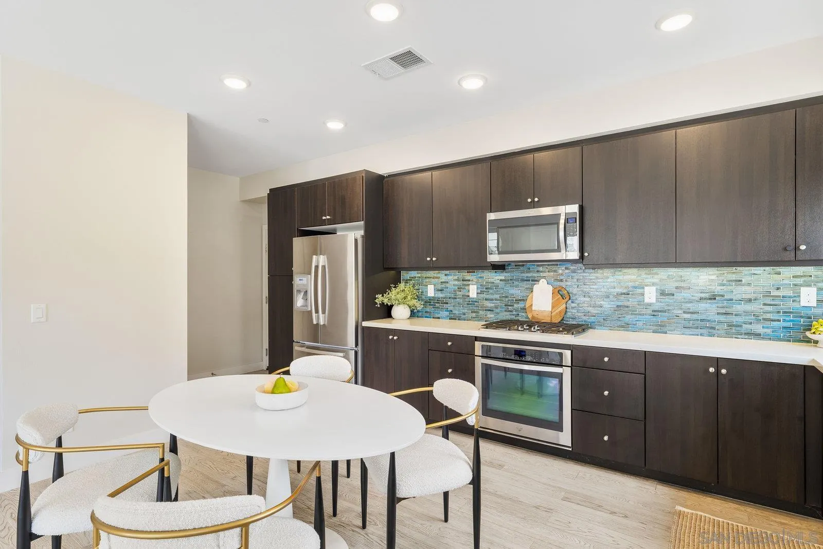 1676 Shorebreak Way Encinitas, CA 92024 - Photo 26 of 61 a kitchen with a table and chairs in it