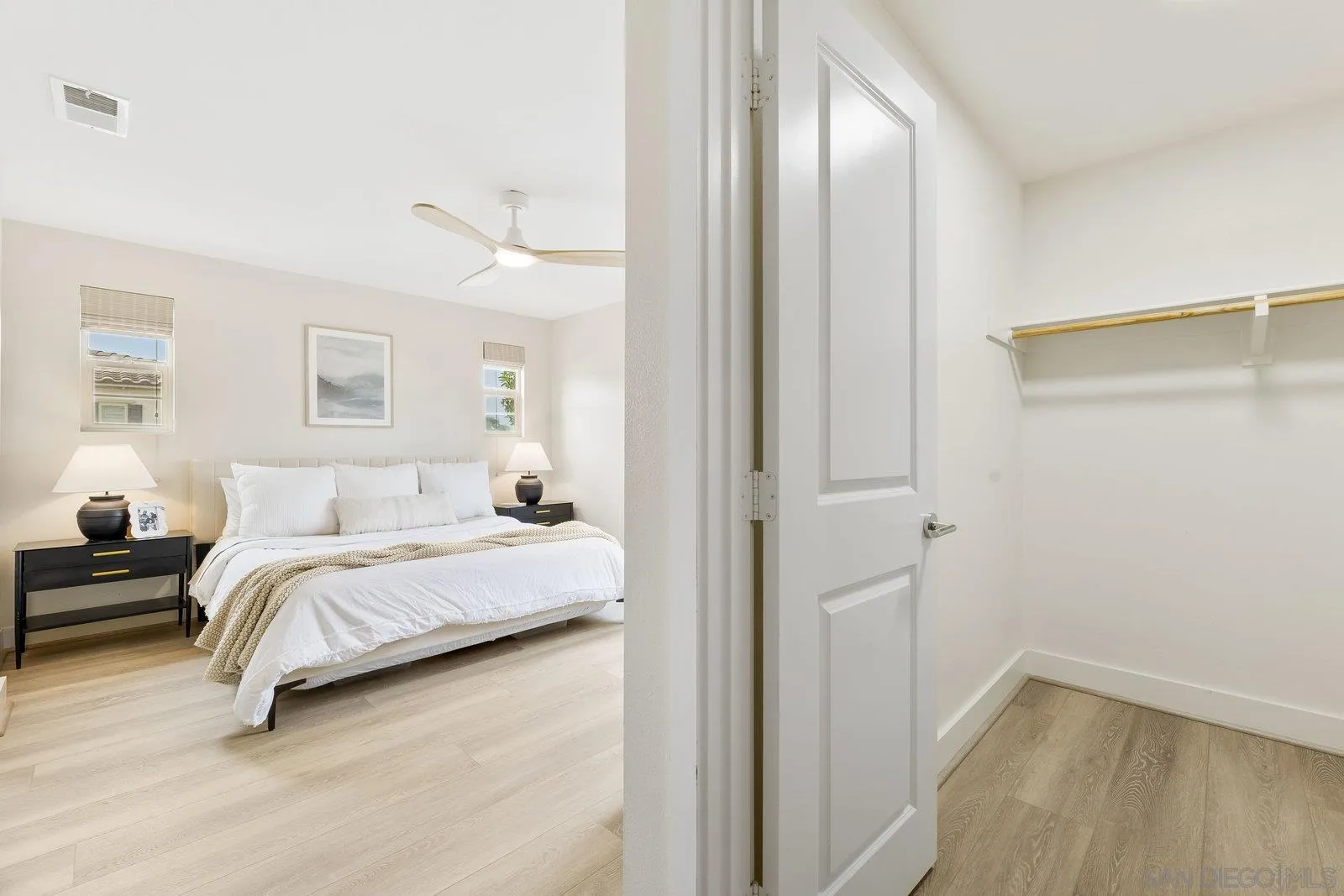 1676 Shorebreak Way Encinitas, CA 92024 - Photo 32 of 61 a bedroom with a bed and a walk in closet