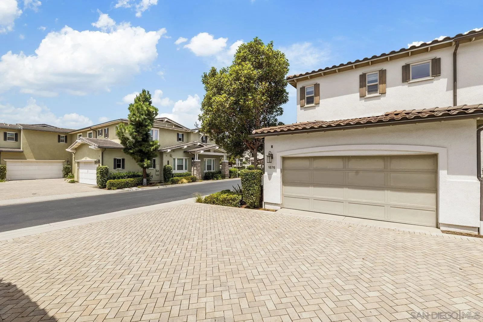 1676 Shorebreak Way Encinitas, CA 92024 - Photo 42 of 61 a front view of a house with a yard and garage