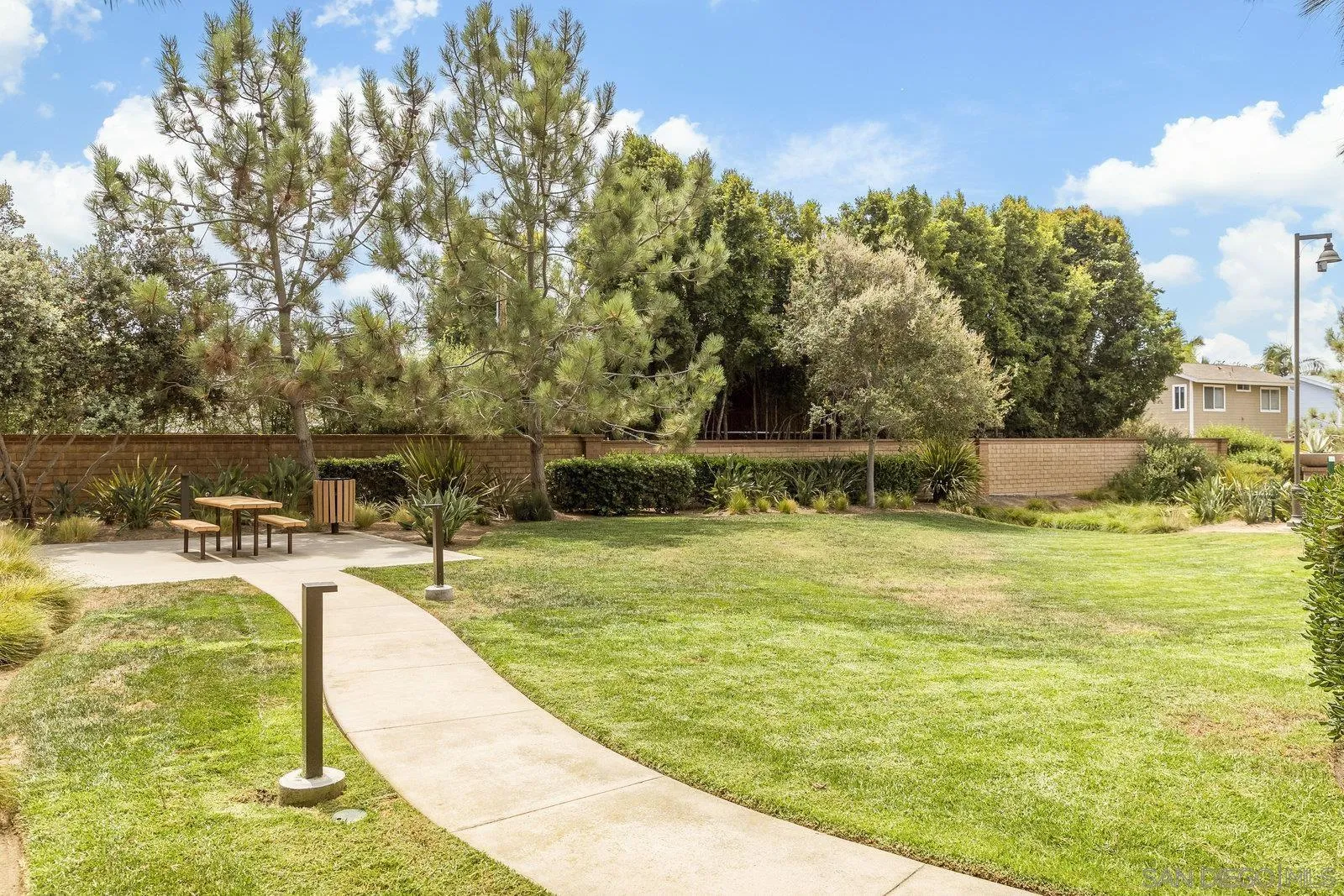 1676 Shorebreak Way Encinitas, CA 92024 - Photo 45 of 61 a swimming pool with some trees in the background