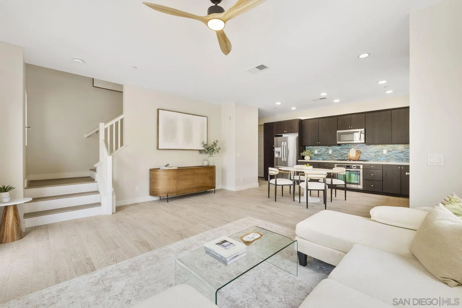 1676 Shorebreak Way Encinitas, CA 92024 - Photo 6 of 61 a living room with furniture and kitchen view