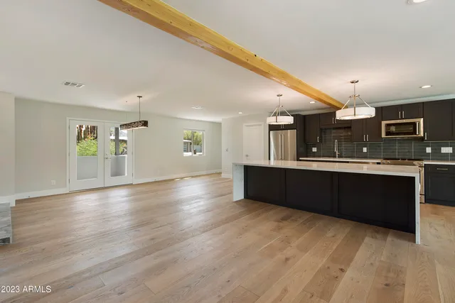 a view of kitchen with stainless steel appliances granite countertop cabinets and wooden floor