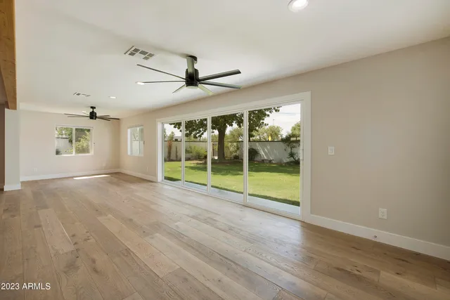 a bathroom with a granite countertop sink mirror and toilet