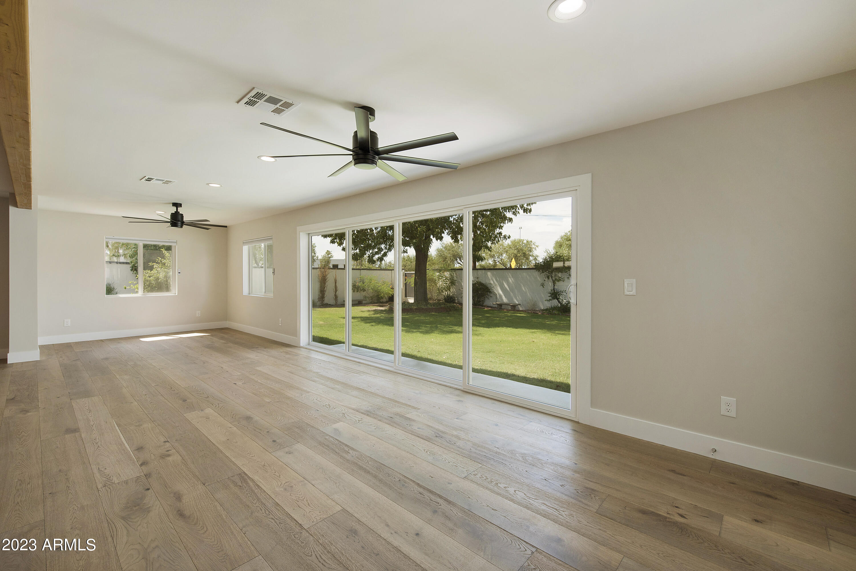 3318 East Onyx Avenue Phoenix, AZ 85028 - Photo 20 of 55 an empty room with wooden floor and windows