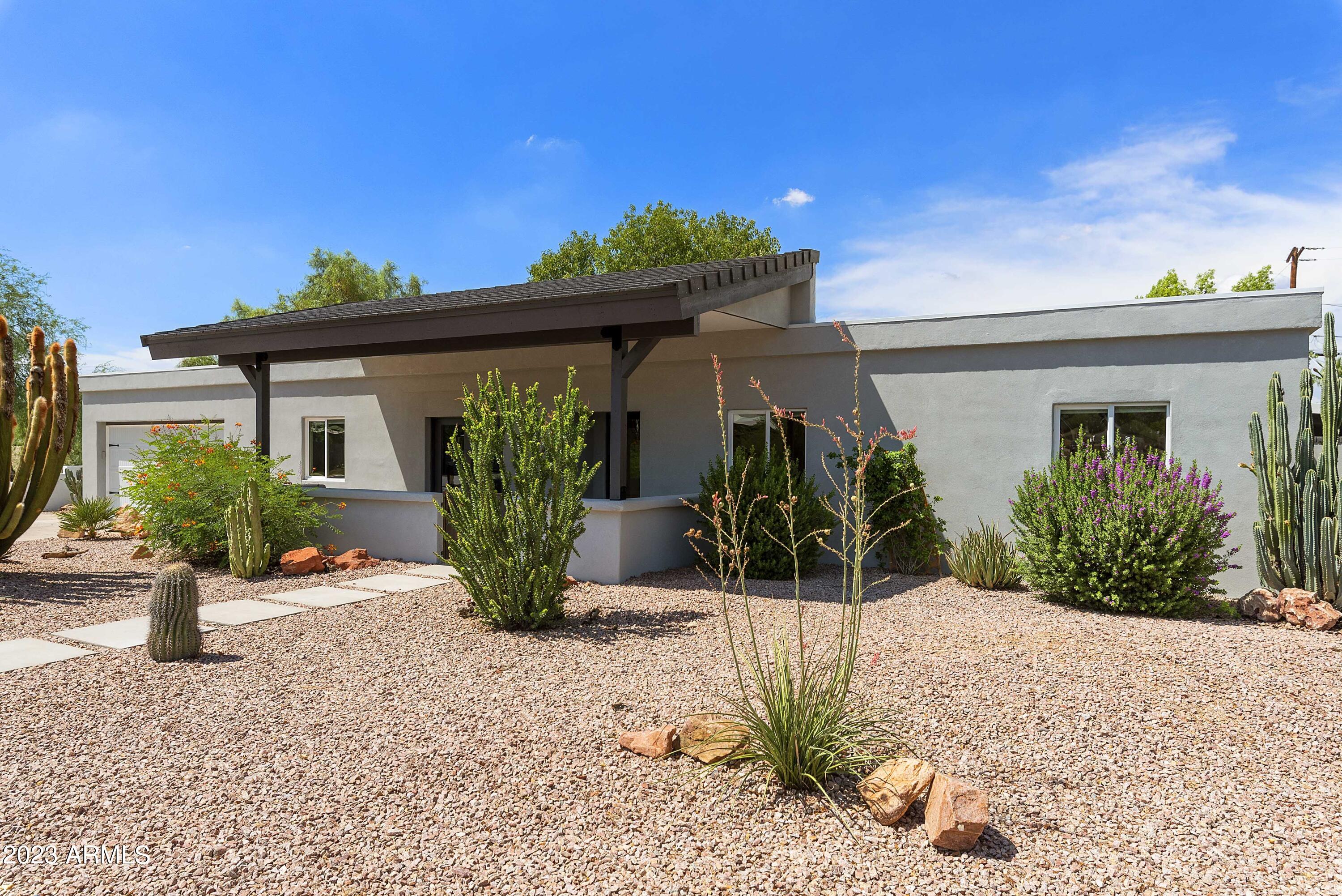 3318 East Onyx Avenue Phoenix, AZ 85028 - Photo 2 of 55 a view of a house with potted plants