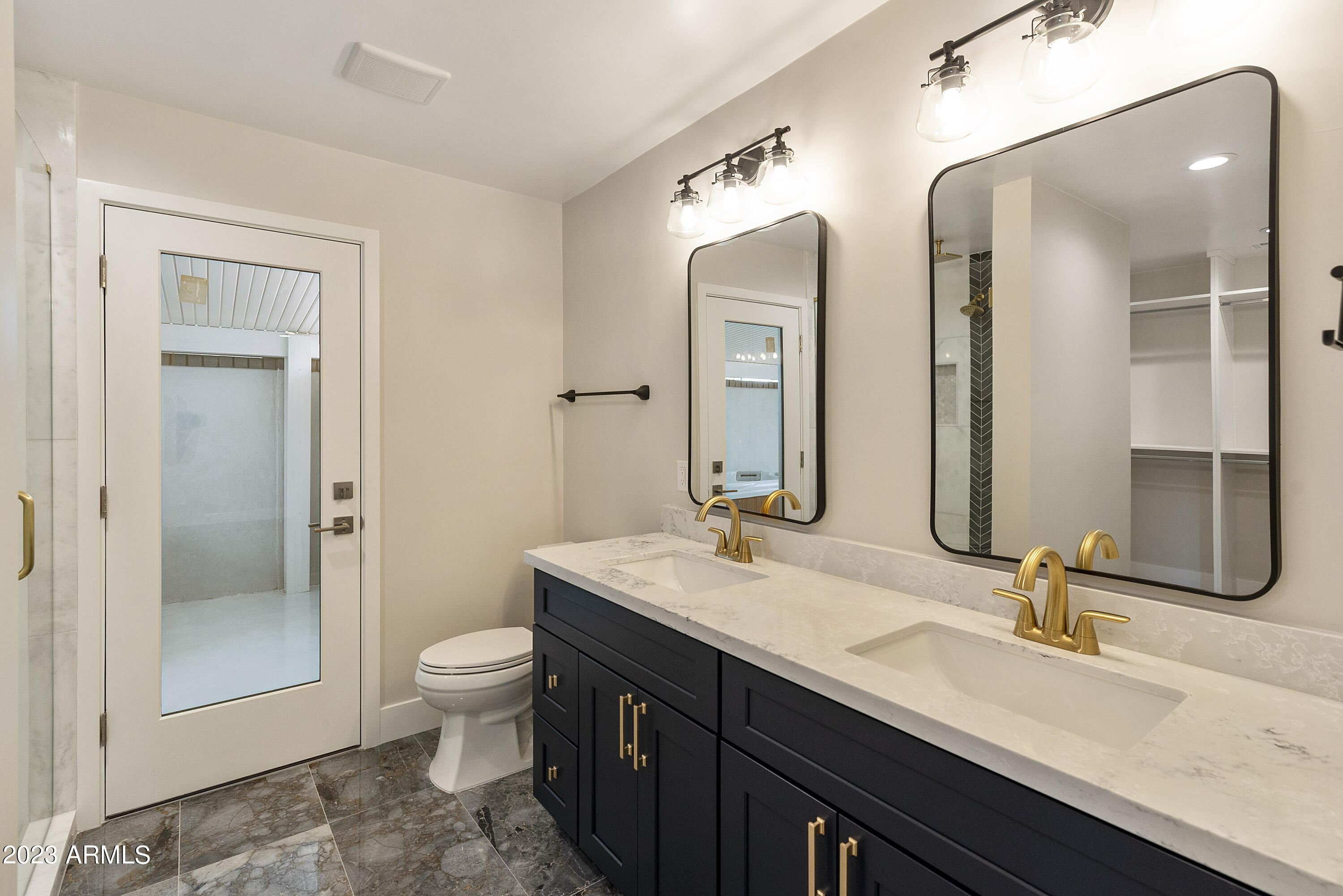 3318 East Onyx Avenue Phoenix, AZ 85028 - Photo 22 of 55 a bathroom with a granite countertop sink mirror and toilet