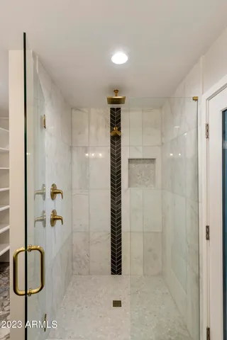 a view of a white house with a large tree in front of it