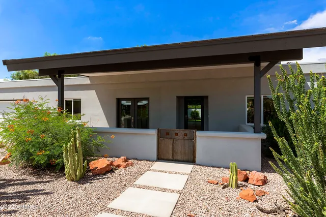 a backyard of a house with potted plants