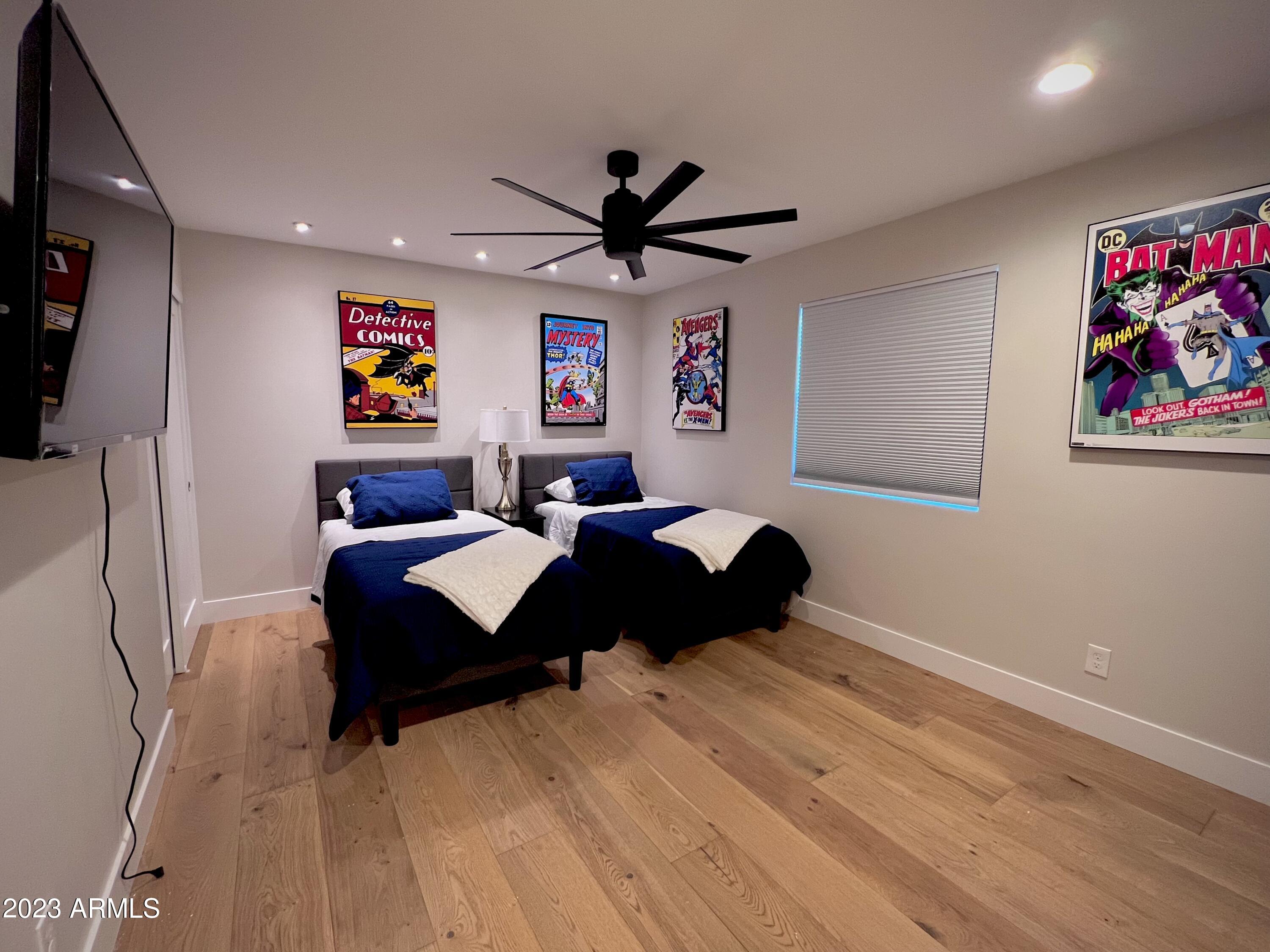 3318 East Onyx Avenue Phoenix, AZ 85028 - Photo 35 of 55 a bedroom with a bed and a chandelier