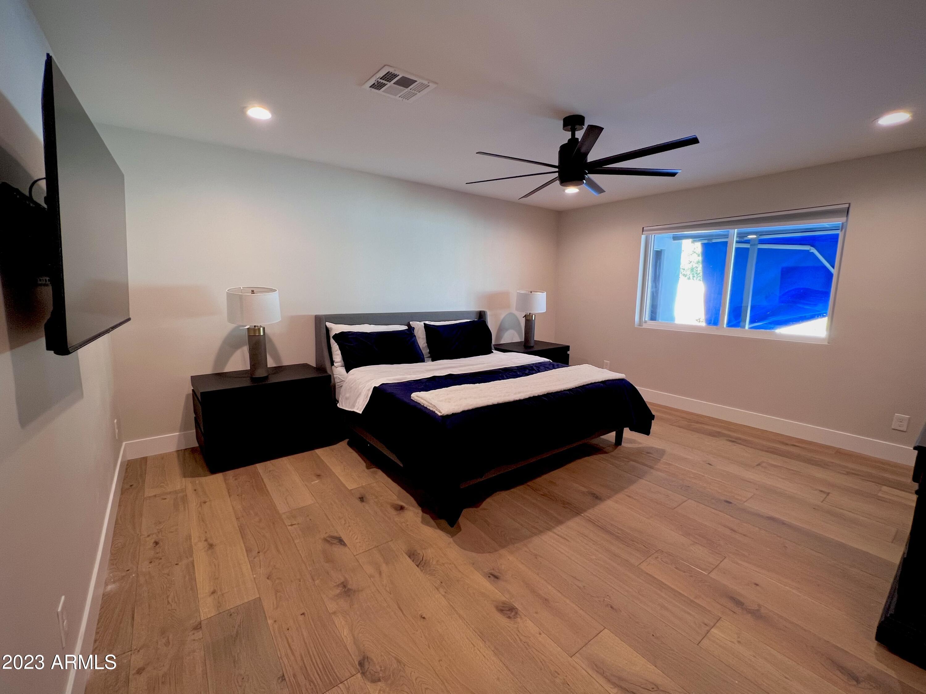 3318 East Onyx Avenue Phoenix, AZ 85028 - Photo 38 of 55 a bedroom with a bed window and a flat screen tv