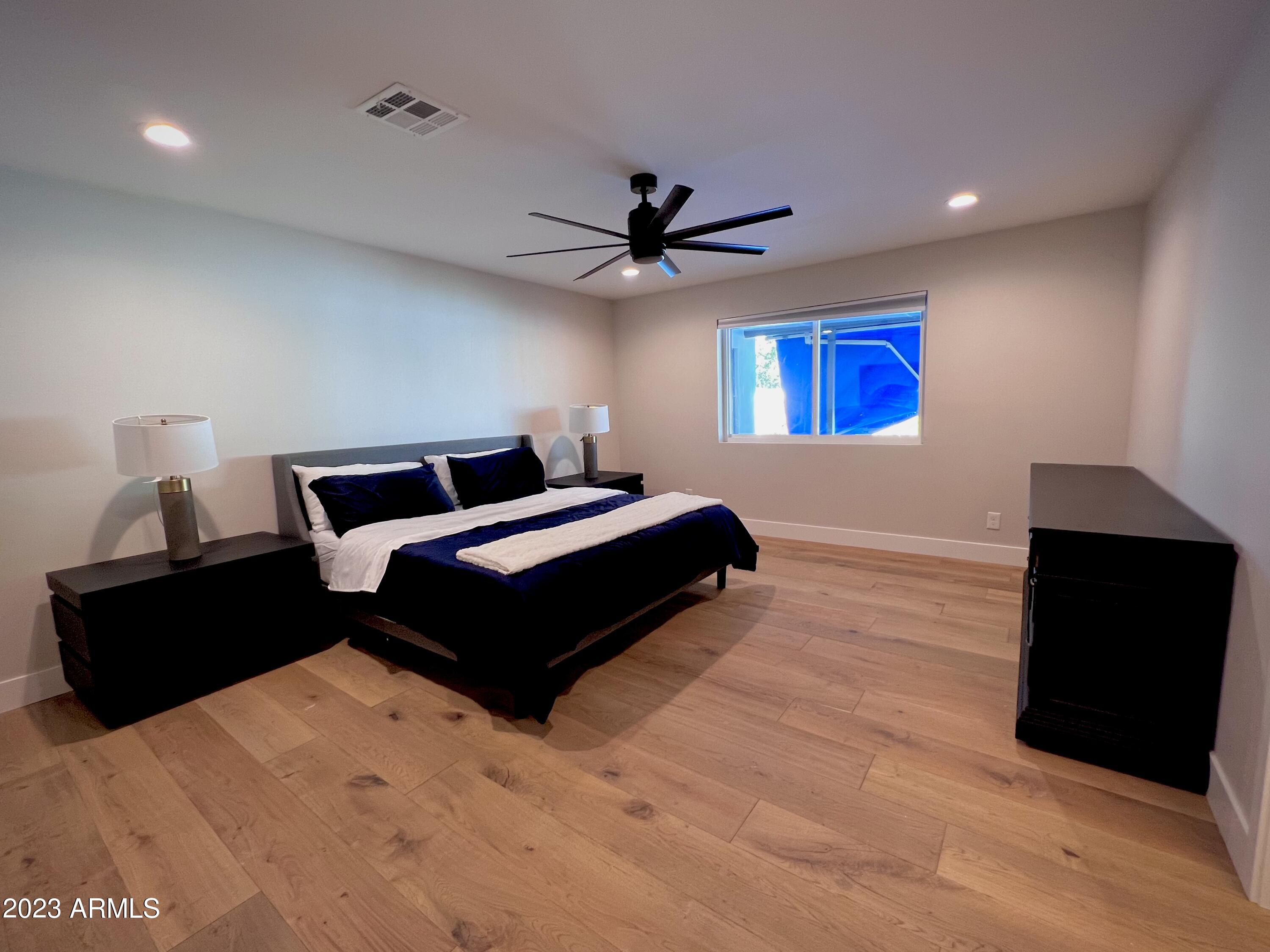 3318 East Onyx Avenue Phoenix, AZ 85028 - Photo 39 of 55 a bedroom with a bed and a ceiling fan