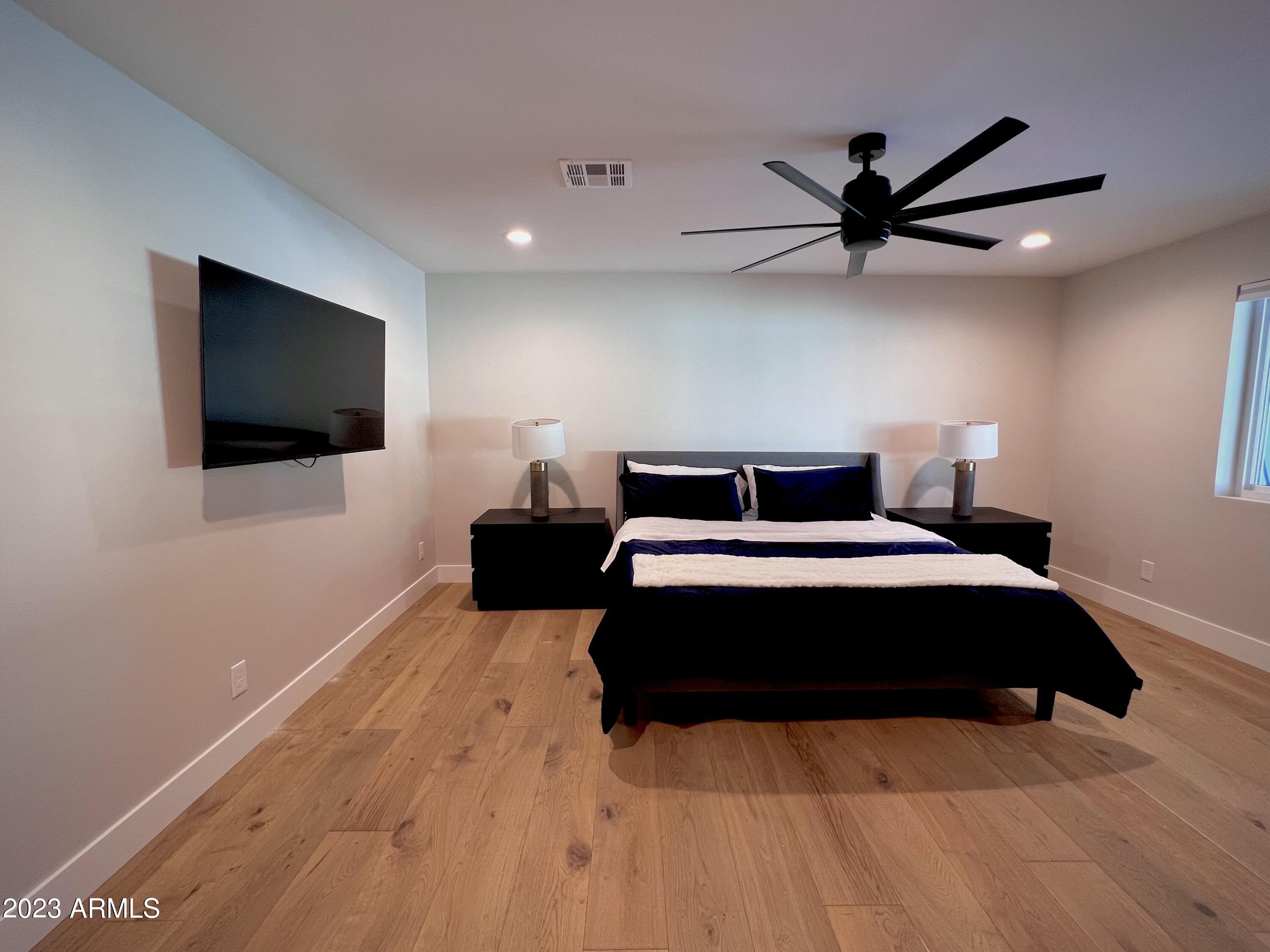 3318 East Onyx Avenue Phoenix, AZ 85028 - Photo 40 of 55 a bedroom with a bed and a flat screen tv