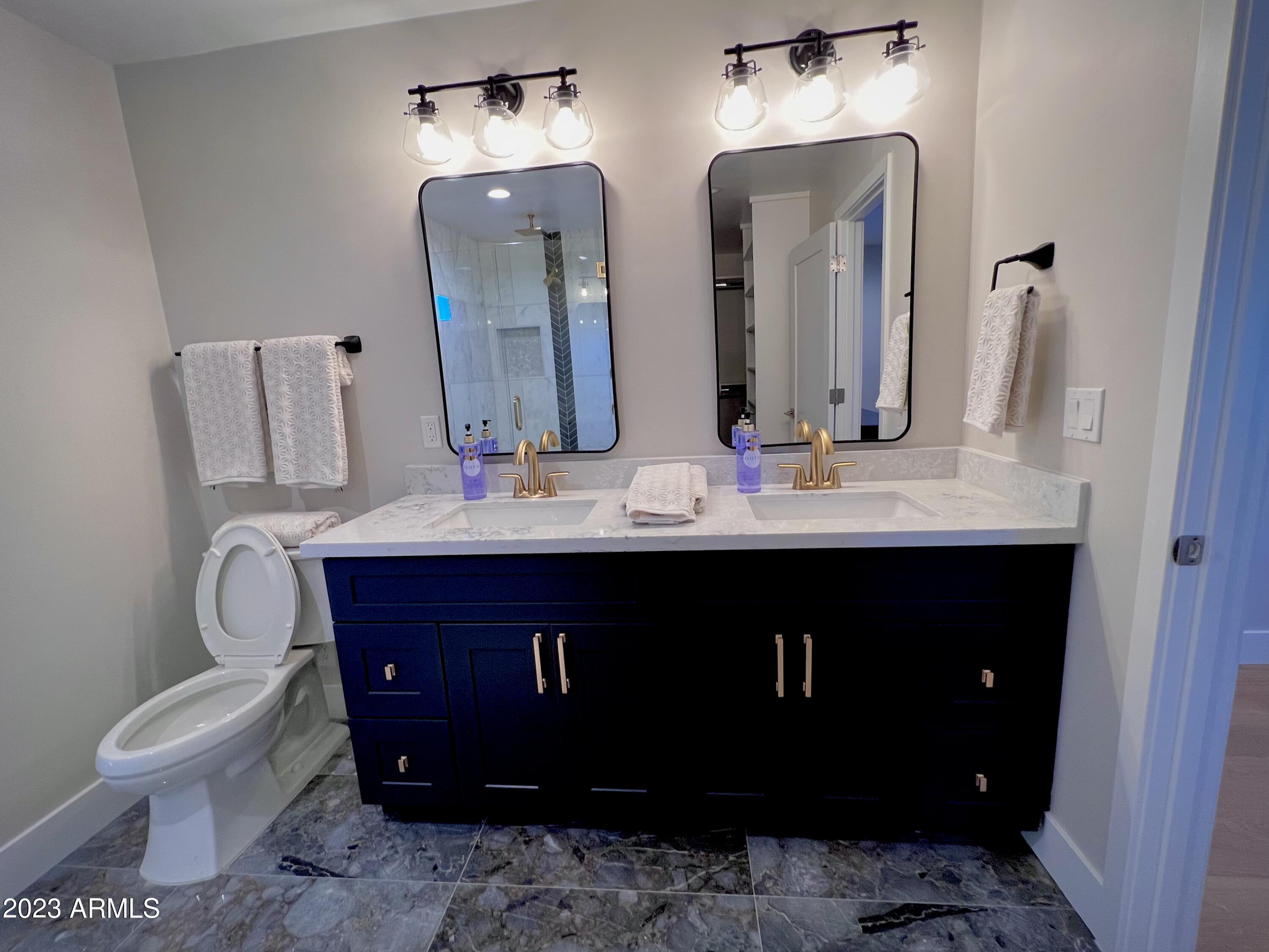 3318 East Onyx Avenue Phoenix, AZ 85028 - Photo 41 of 55 a bathroom with a double vanity sink and a toilet