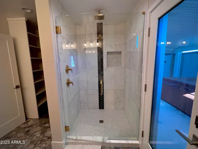 a kitchen with stainless steel appliances a dining table chairs and a refrigerator