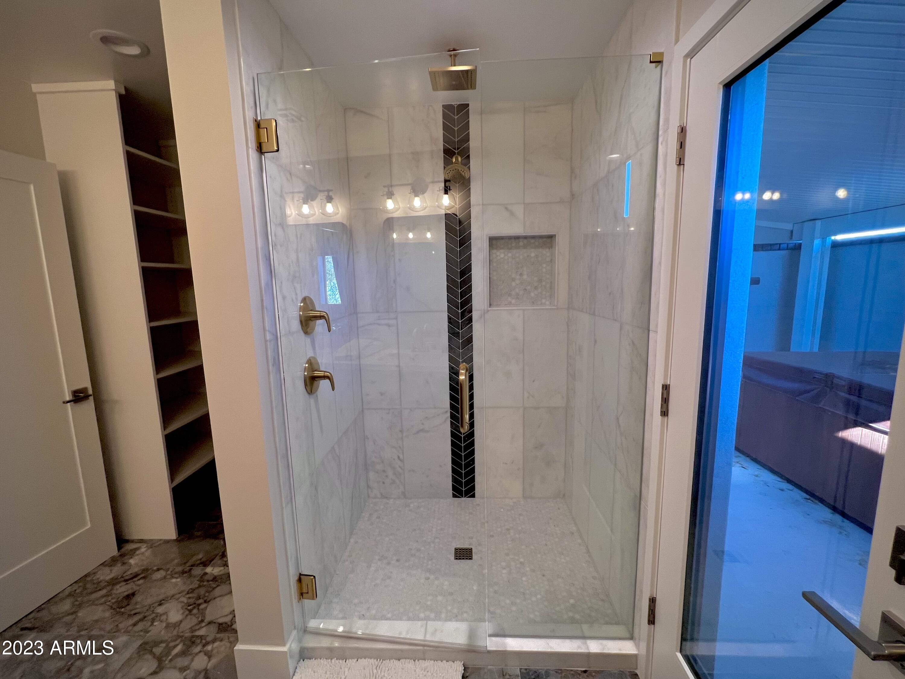 3318 East Onyx Avenue Phoenix, AZ 85028 - Photo 42 of 55 a bathroom with a shower and a glass door