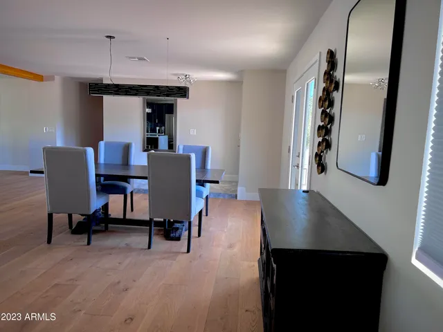 a living room with furniture pool table and a ceiling fan