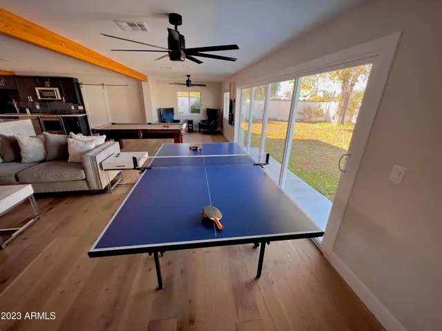 a living room with furniture a table and a flat screen tv
