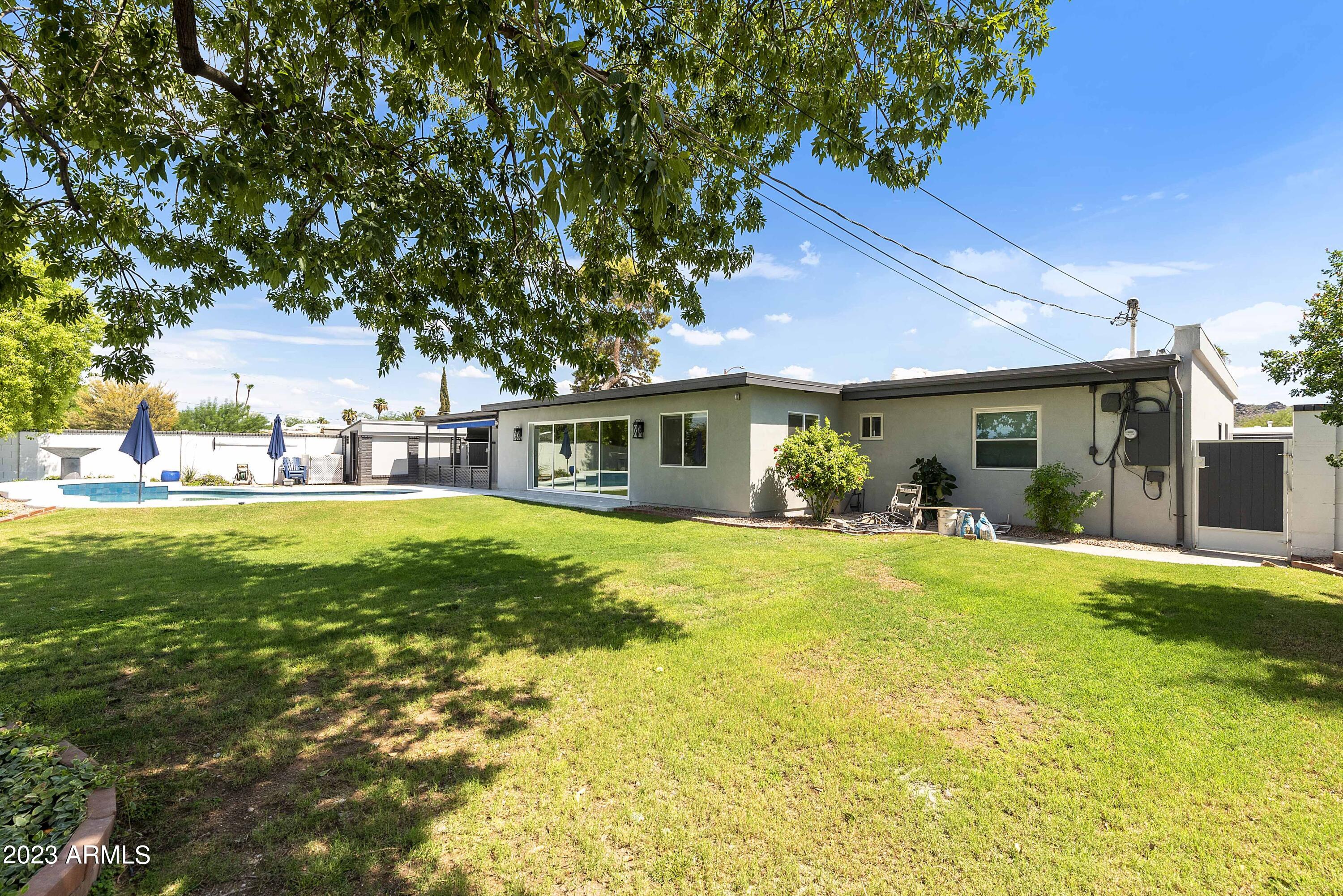 3318 East Onyx Avenue Phoenix, AZ 85028 - Photo 6 of 55 a front view of a house with a garden
