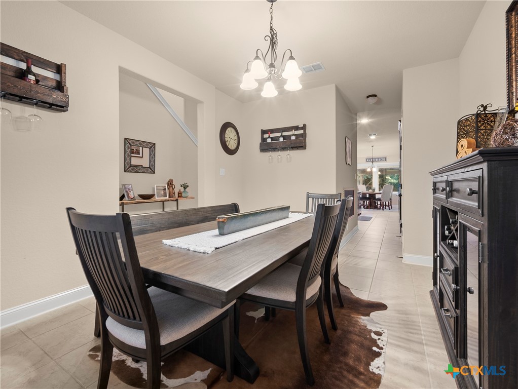 28415 Willis Ranch San Antonio, TX 78260 - Photo 13 of 48 a view of a dining room with furniture and a chandelier