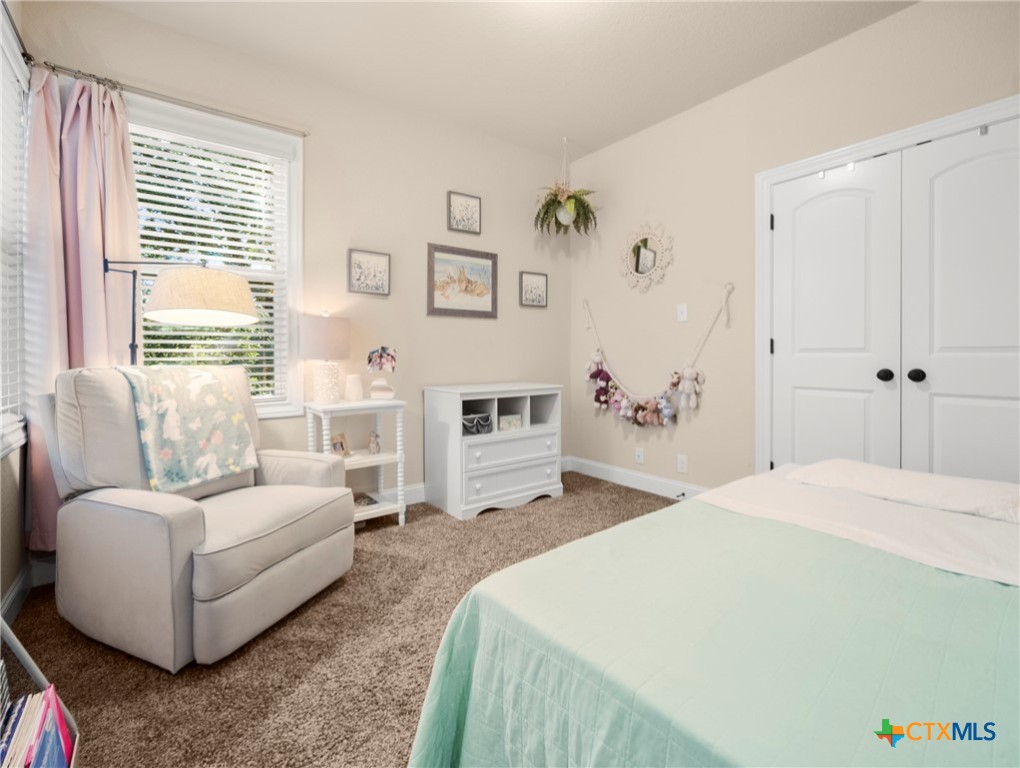 28415 Willis Ranch San Antonio, TX 78260 - Photo 29 of 48 a bedroom with a bed couch and a window