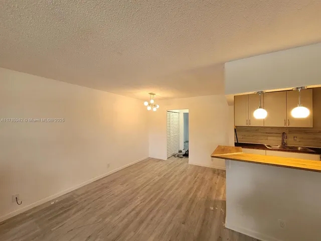 a view of a room with a sink and a microwave