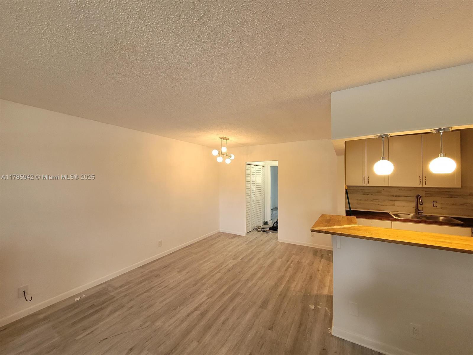 a view of a room with a sink and a microwave
