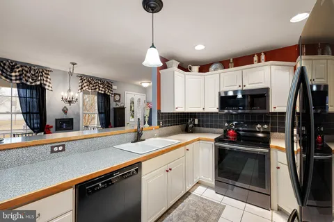 a kitchen with stainless steel appliances a sink stove and refrigerator