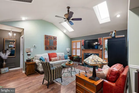 a living room with furniture a rug and a chandelier