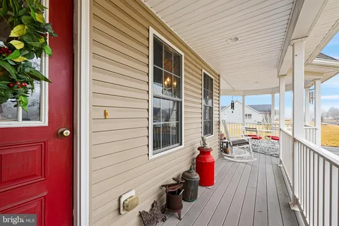 a view of balcony with chairs and wooden fence