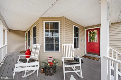 a view of a house with chairs and a potted plant