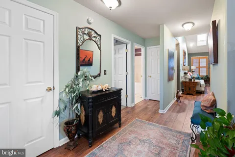 a living room with furniture a mirror and a fireplace